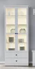 A tall, white display cabinet with glass doors and interior lighting. Produktbild-Vorschau
