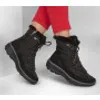 A pair of black winter boots worn by a person wearing red pants. Produktbild-Vorschau
