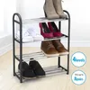 A four-tier metal shoe rack filled with various shoes, placed in a well-lit room with a light-colored floor and wall. Voir les images du produit