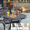 An outdoor dining set with a round table and chairs, set on a patio with a house in the background. Produktbild-Vorschau