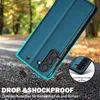 A teal flip phone case is shown in a dynamic, slightly angled shot, with a blurred background of trees and a road. The case appears to be falling, with small brown debris scattered around it, emphasizing its protective qualities. A small inset circle highl Produktbild-Vorschau