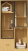 A multi-level cat furniture unit with enclosed spaces, shelves, and scratching posts, featuring two cats. Podgląd zdjęcia produktu