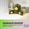 A green dinosaur-shaped reading pillow is placed on a bed. Podgląd zdjęcia produktu