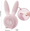 A pink bunny-shaped alarm clock with a digital display and a close-up inset showing the material flexibility. Produktbild-Vorschau