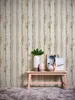 A decorative arrangement on a shelf against a wood-patterned wallpaper. Produktbild-Vorschau