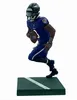A figurine of a football player on a green base. Anteprima dell’immagine prodotto