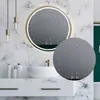 A modern bathroom vanity with a round LED mirror, sink, and faucet. Voir les images du produit
