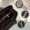 A close-up view of the interior of a black leather handbag, with three circular insets showing decorative elements of the bag. Produktbild-Vorschau