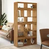 A room divider bookshelf with various decorative items placed on its shelves, next to a sofa. Podgląd zdjęcia produktu