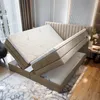 A bedroom scene with a bed frame open to reveal storage space. Voir les images du produit