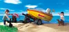 A family is preparing to launch a boat from a trailer on a sandy beach with the ocean in the background. Podgląd zdjęcia produktu