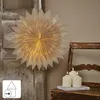 A paper star lantern hangs on a rustic wooden door next to a vintage chair with three LED candles on a book. Podgląd zdjęcia produktu