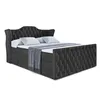 A dark gray upholstered boxspring bed with a tufted headboard and footboard, set against a white background. Produktbild-Vorschau