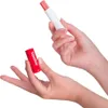Hands holding a Vaseline lip balm stick and its cap. Produktbild-Vorschau
