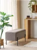A modern living room with a plant, a storage bench, and a desk. Podgląd zdjęcia produktu