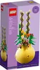 The image shows the packaging of a LEGO set, specifically the 40588 Flower Pot set. The packaging is purple and features an image of the assembled LEGO flower pot with flowers and branches. Podgląd zdjęcia produktu