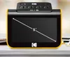A Kodak film scanner is displayed on a white surface with a blurred background. Podgląd zdjęcia produktu