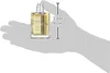 A hand is holding a perfume bottle, with a ruler indicating its size. Podgląd zdjęcia produktu
