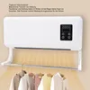 A white wall-mounted heater with a drying rack below, holding several garments. Warm light emanates from the heater.