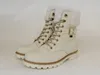 A pair of white winter boots with fur trim and gold accents, presented on a white background. Produktbild-Vorschau
