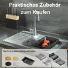 A kitchen sink with accessories, including a knife block and various small baskets. Produktbild-Vorschau