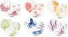 A collage of multiple ceramic plates and bowls, each featuring a different animal or plant illustration. Podgląd zdjęcia produktu