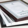 A stack of picture frames with certificates inside, viewed from a diagonal angle. Produktbild-Vorschau