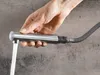 A hand is holding a faucet sprayer with water running. Podgląd zdjęcia produktu
