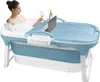 A woman is relaxing in a portable bathtub with a laptop, a glass of wine, and a bottle of wine on a tray attached to the tub. Náhled obrázku produktu