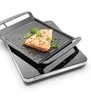 A grilled salmon fillet is placed on a grill pan, which is on top of an induction cooker. Anteprima dell’immagine prodotto