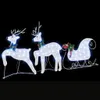 Three illuminated reindeer pulling a sleigh against a black background. Podgląd zdjęcia produktu