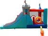 An inflatable castle bounce house with a slide and basketball hoop, shown outdoors against a white background. A blower is attached to the side. Náhled obrázku produktu