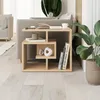 A modern living room setting with a couch, a plant, and a wooden side table. Produktbild-Vorschau