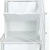 A close-up view of the interior of a white wooden storage unit, showing shelves and a drawer. Produktbild-Vorschau