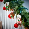 LEGO gingerbread man ornaments hanging on a Christmas tree with red baubles. Produktbild-Vorschau