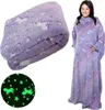A collage showing a folded blanket with a unicorn and star pattern and a woman wearing a blanket with sleeves with the same pattern. Náhľad obrázku produktu