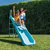 A young girl slides down a blue garden slide while a woman stands behind her. Náhled obrázku produktu