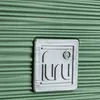 A close-up of a green planter with a silver logo. Produktbild-Vorschau