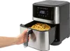 A person's hand is pulling out the basket of an air fryer filled with french fries. The air fryer has a digital display showing '200'. Produktbild-Vorschau