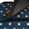 A close-up view of a blue picnic blanket with white polka dots, showing a section of the material and a hook-and-loop fastener. Náhled obrázku produktu