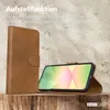 A brown leather flip phone case is shown standing upright, with a smartphone placed inside and propped up by the case, displaying a colorful wallpaper. The background is a textured, light brown wall. Produktbild-Vorschau