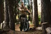 A man is sitting on an electric bike in a forest. Anteprima dell’immagine prodotto