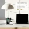 A desk setup with a wireless charging station, laptop, and lamp. Produktbild-Vorschau