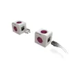 Two white cube-shaped power adapters with purple outlets are shown on a white background. One adapter has a plug inserted into it, and the other has a cable extending from it. Produktbild-Vorschau