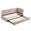 A pink upholstered daybed with a pull-out trundle bed is shown against a white background. Podgląd zdjęcia produktu