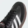 A close-up view of the toe and laces of a black Adidas Samba sneaker. Náhled obrázku produktu