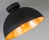 A close-up shot of a black ceiling lamp with a gold interior, showing the light bulb. Anteprima dell’immagine prodotto