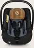A close-up front view of a black and gray baby car seat with a brown headrest overlay. Anteprima dell’immagine prodotto
