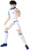 A full-body shot of an articulated action figure of a male soccer player in a white and blue uniform, posed in a dynamic stance. Produktbild-Vorschau