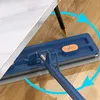 A mop cleaning the floor under a table. Voir les images du produit